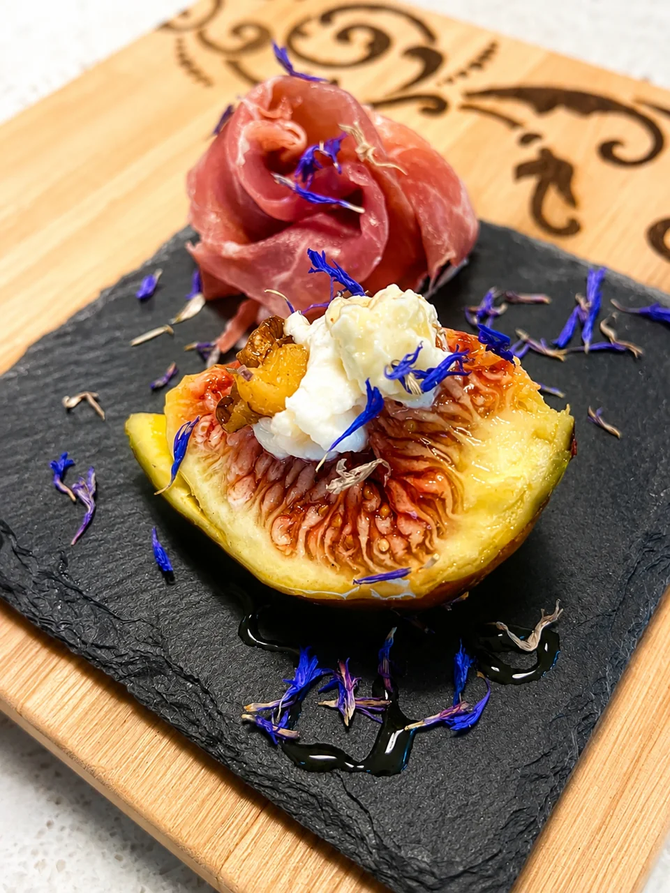 A fig dish with cured meat and cheese