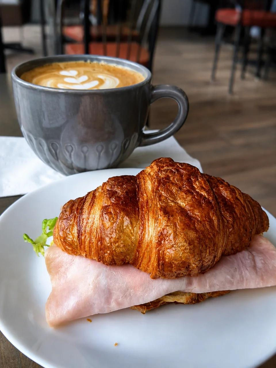 Coffee and a filled croissant served at a Pria